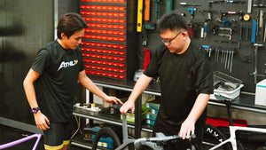 BikeCraft.One technicians working on a road bike at the service bench